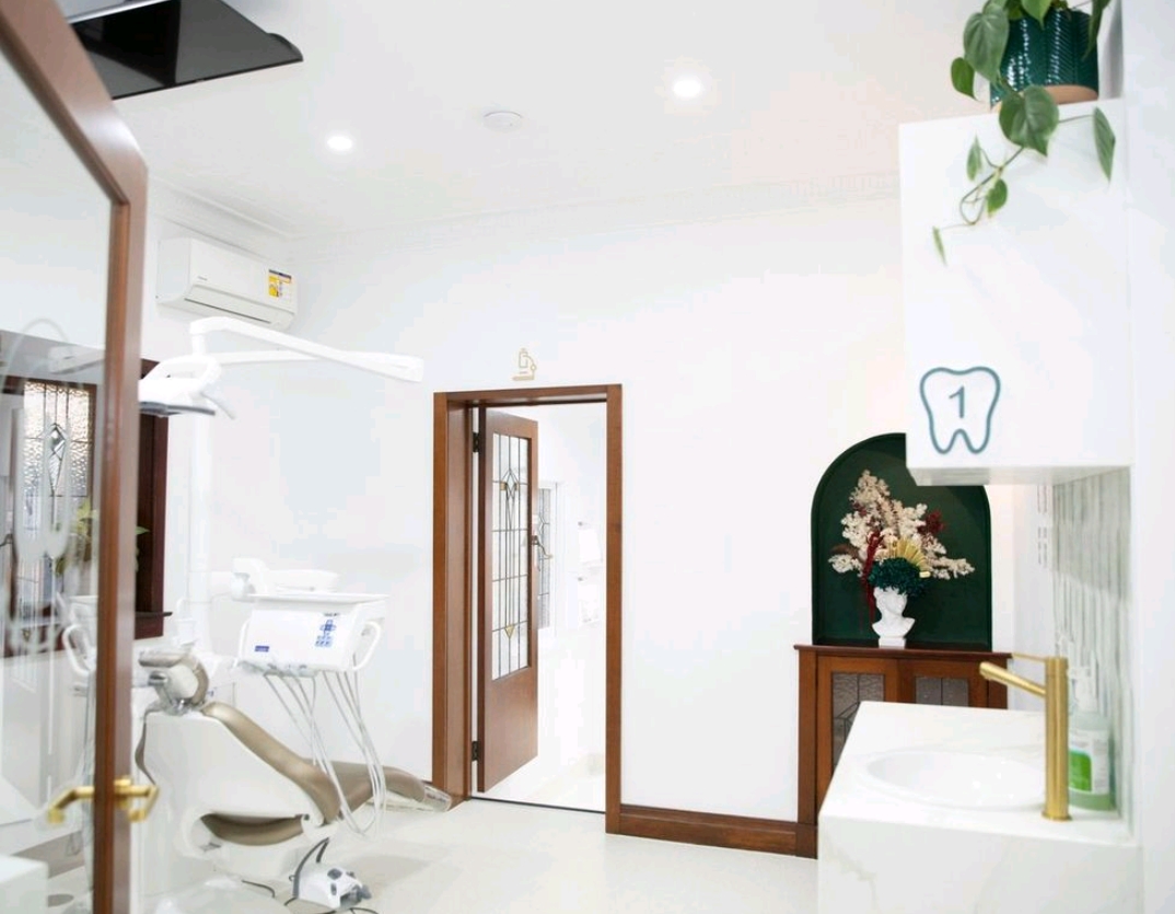 Wired Orthodontics treatment room one with tooth numbering, arched green niche and brass tapware