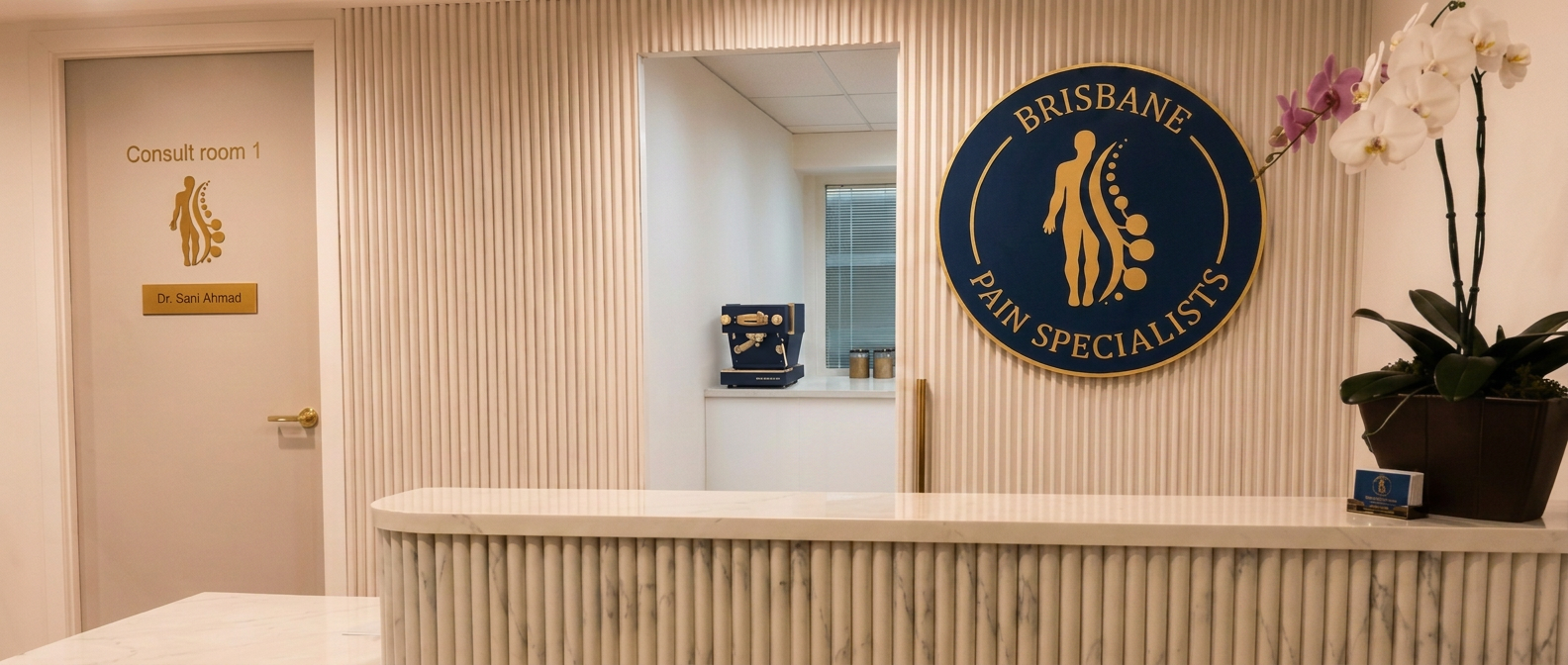 Brisbane Pain Specialists reception with fluted marble desk and brand signage